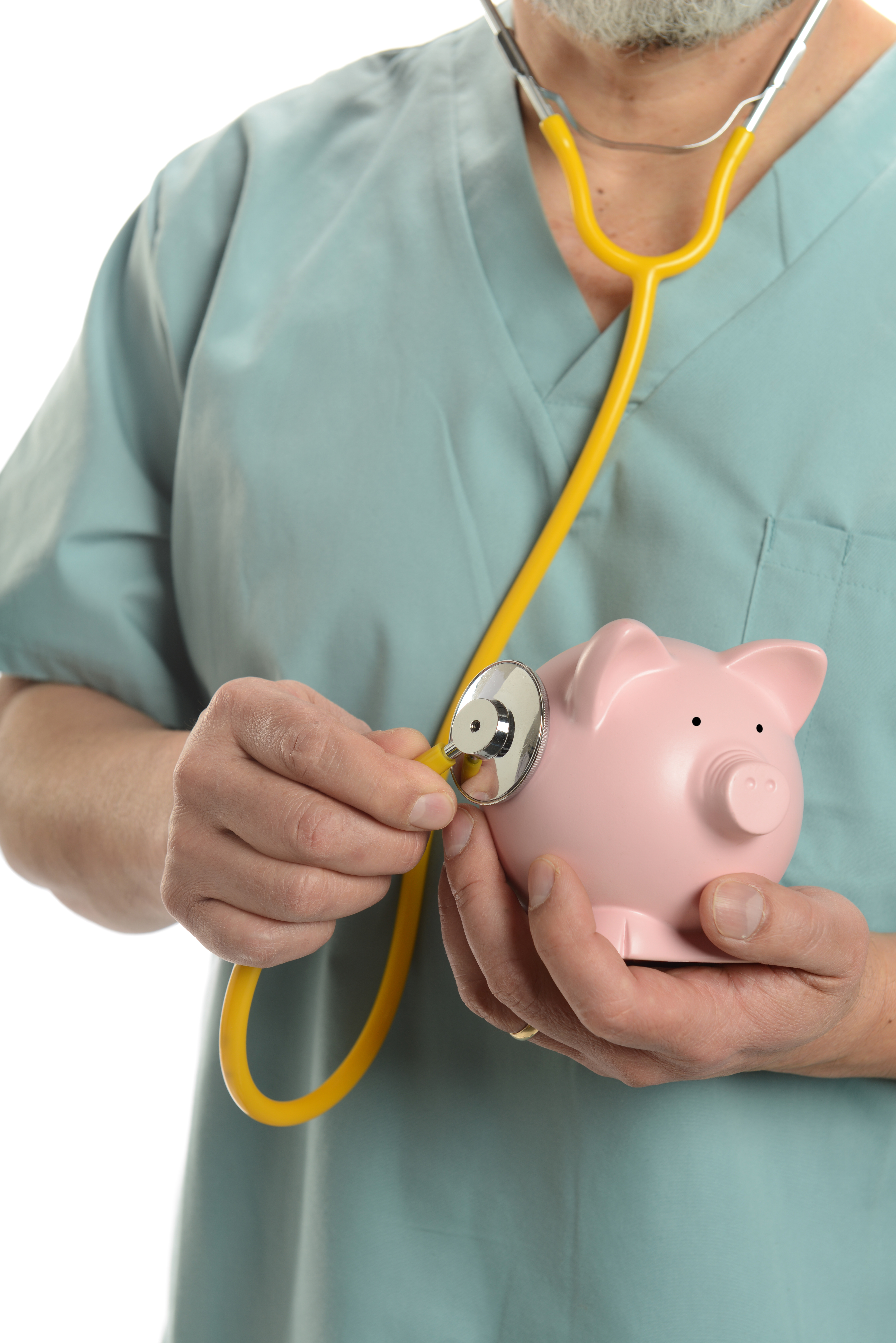 Doctor close up with stethoscope and piggy bank isplated on a white background
