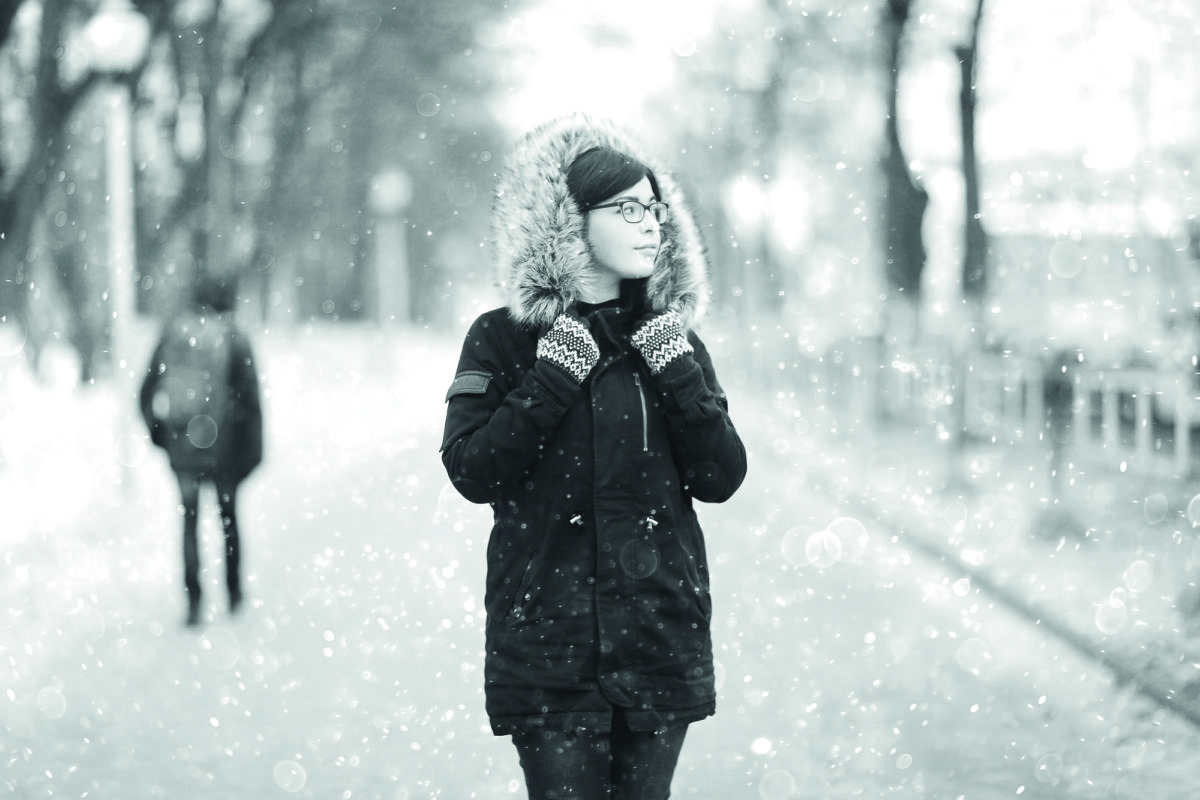 portrait of a girl in a snowy winter park Christmas Walk
